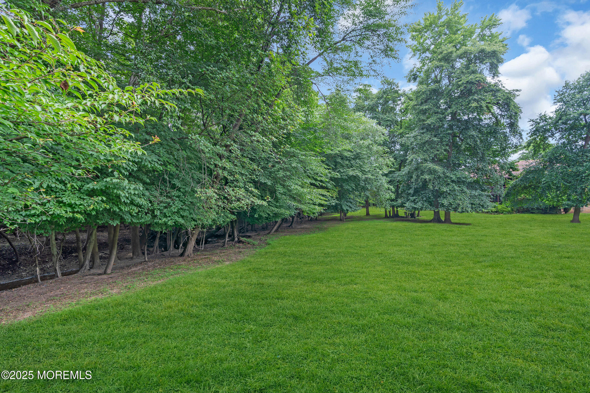 70 Overlook Way, Unit A Manalapan, NJ 07726 - Photo 17 of 20 a view of outdoor space with deck and yard