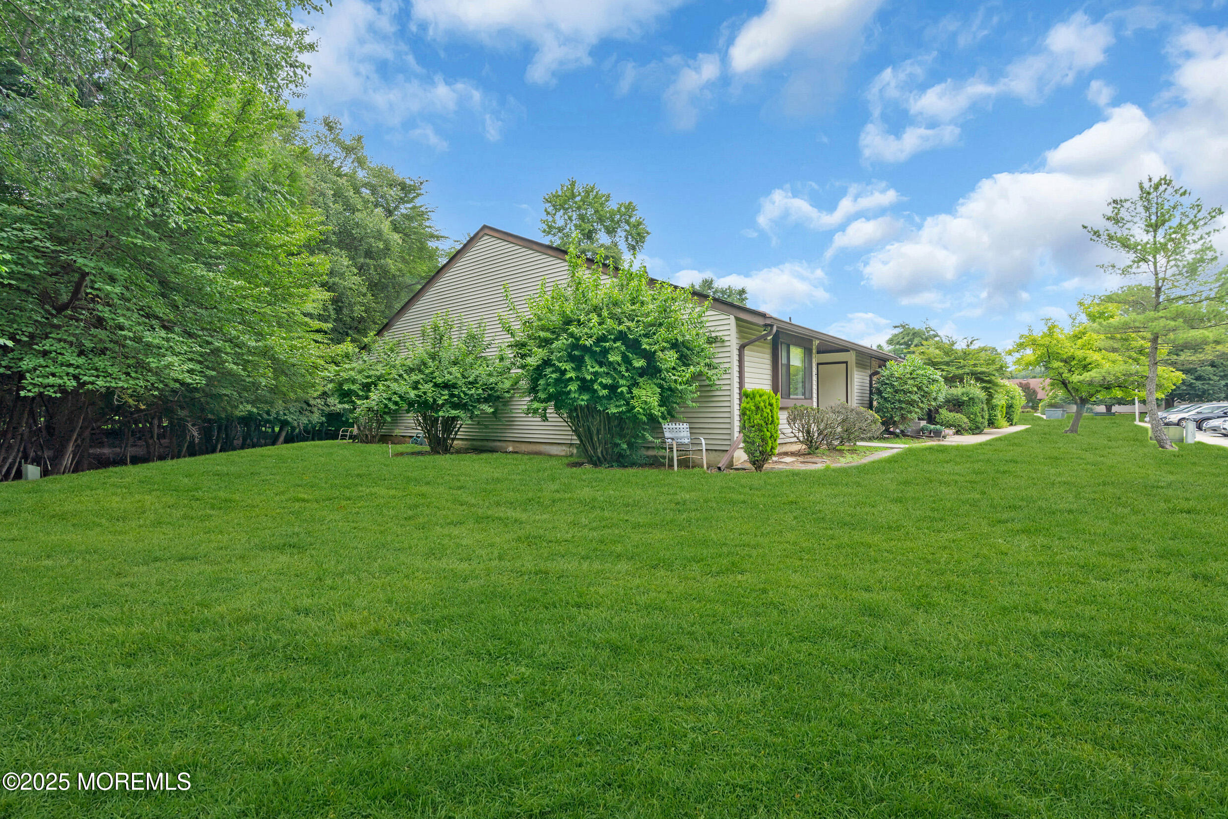 70 Overlook Way, Unit A Manalapan, NJ 07726 - Photo 18 of 20 a view of a house next to a big yard
