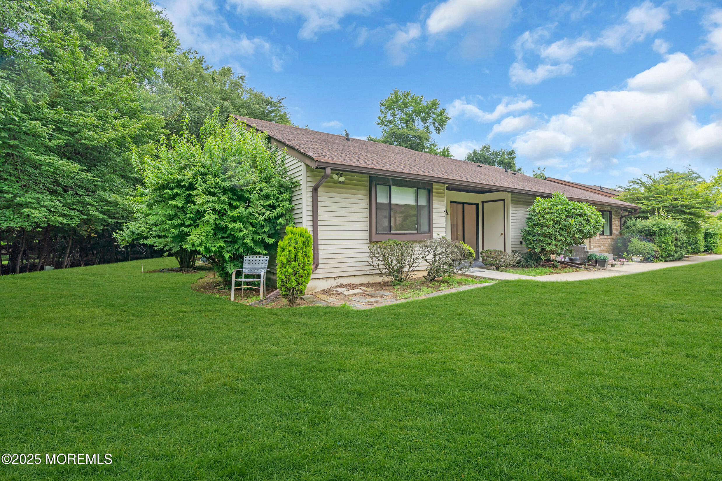 70 Overlook Way, Unit A Manalapan, NJ 07726 - Photo 19 of 20 a front view of house with a garden
