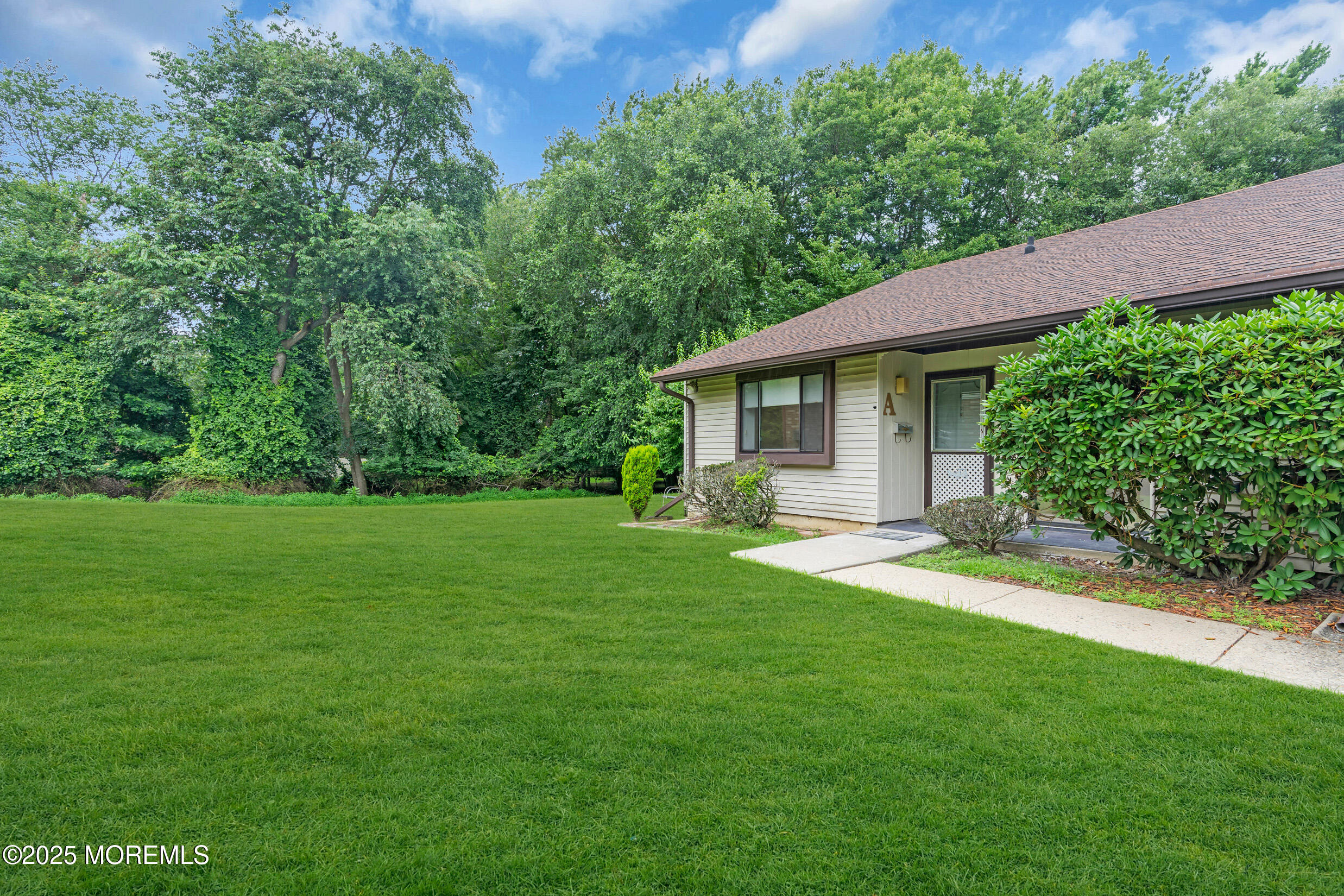 70 Overlook Way, Unit A Manalapan, NJ 07726 - Photo 2 of 20 a view of a house with backyard and garden