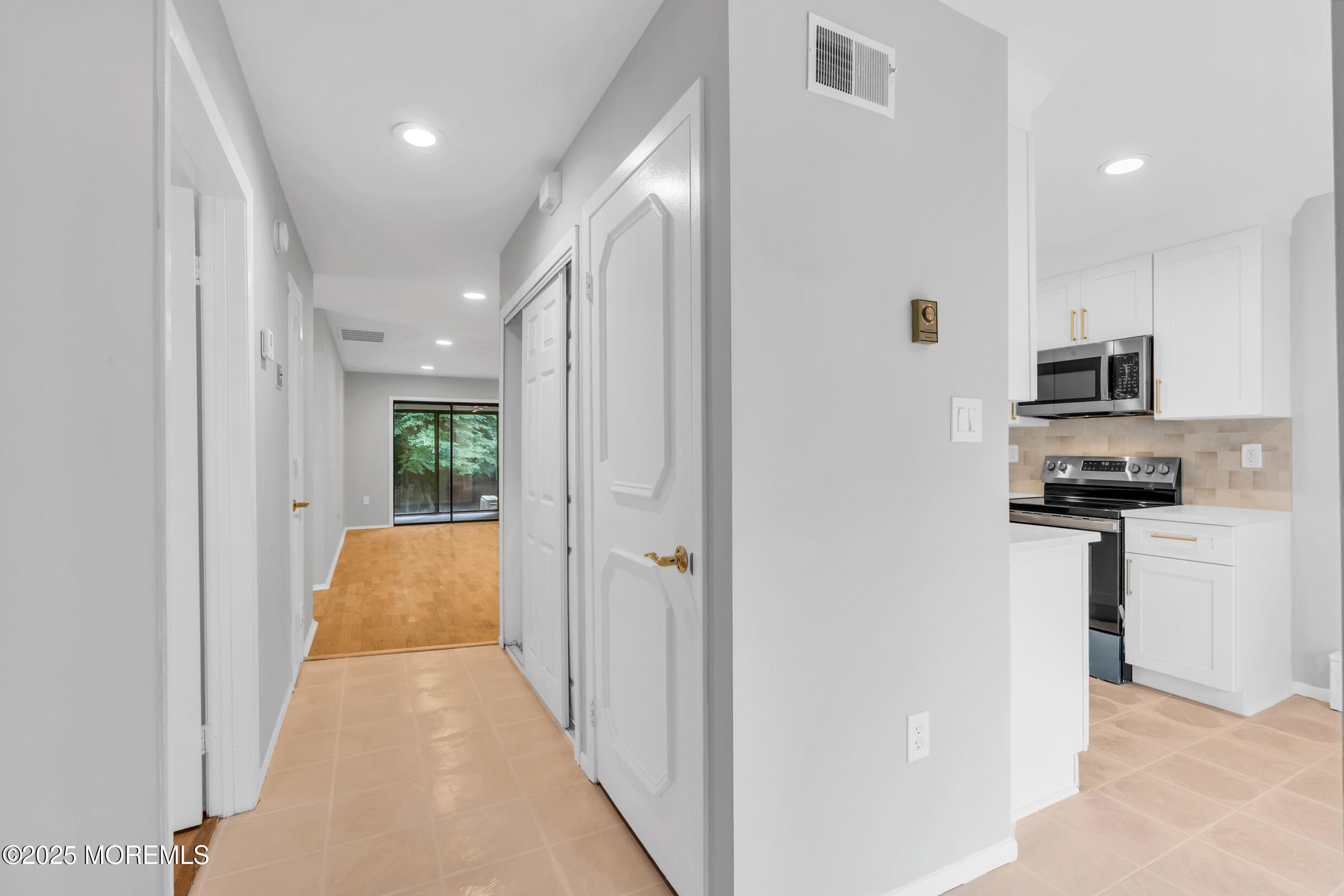 70 Overlook Way, Unit A Manalapan, NJ 07726 - Photo 3 of 20 a view of a hallway with kitchen area