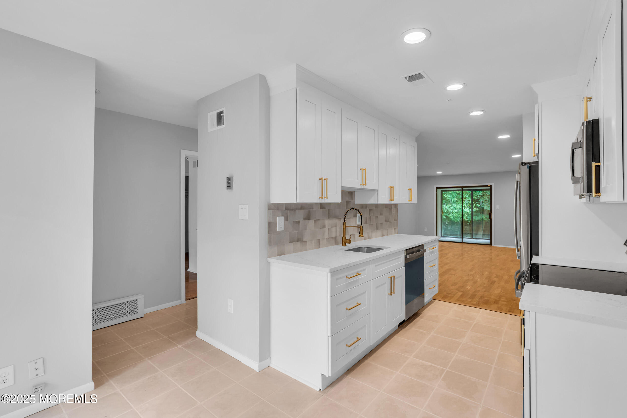 70 Overlook Way, Unit A Manalapan, NJ 07726 - Photo 4 of 20 a large white kitchen with a sink and cabinets
