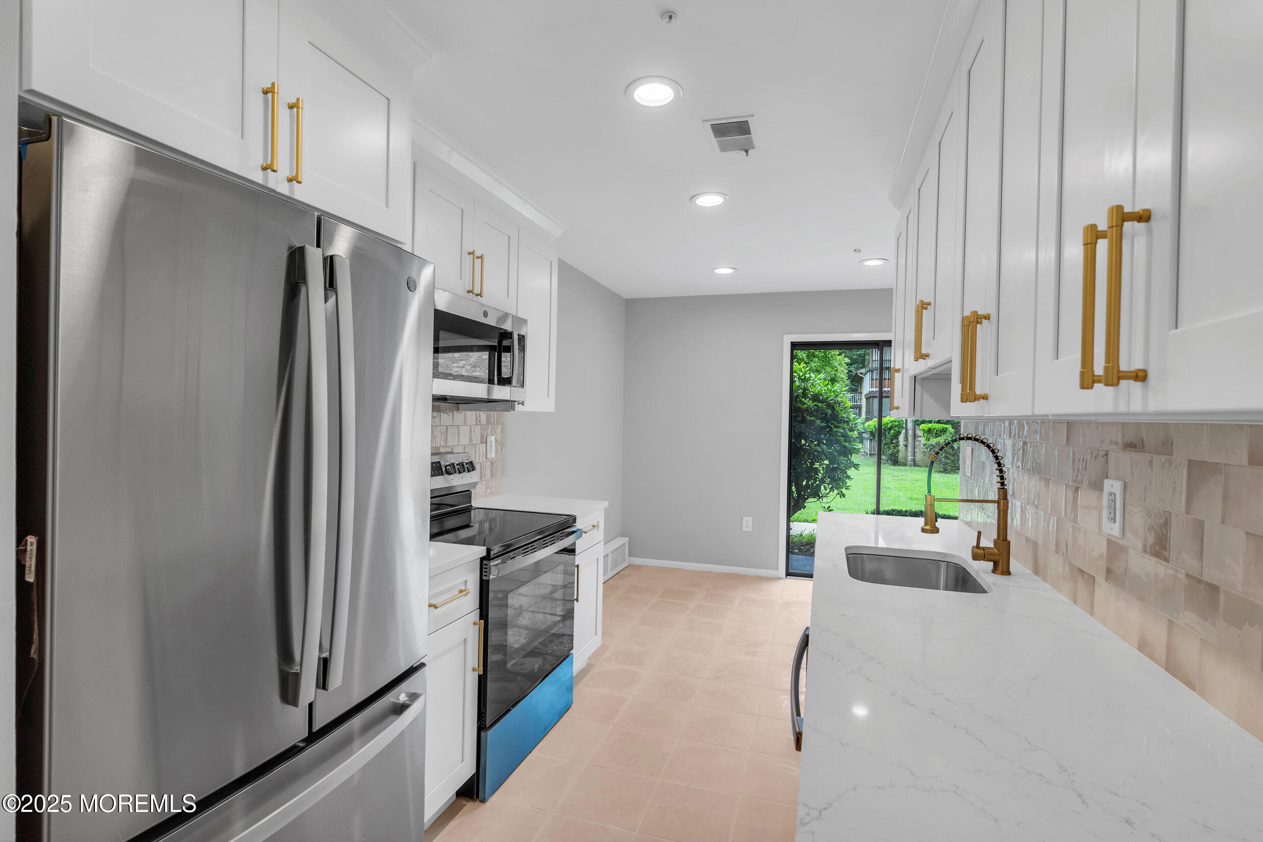 70 Overlook Way, Unit A Manalapan, NJ 07726 - Photo 5 of 20 a kitchen with stainless steel appliances granite countertop a refrigerator and a sink