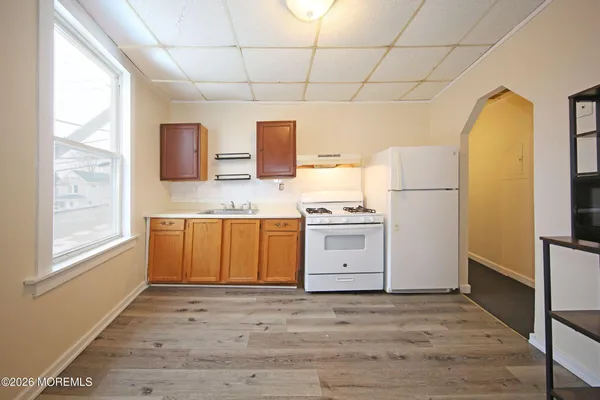 a kitchen with stainless steel appliances a refrigerator sink and stove
