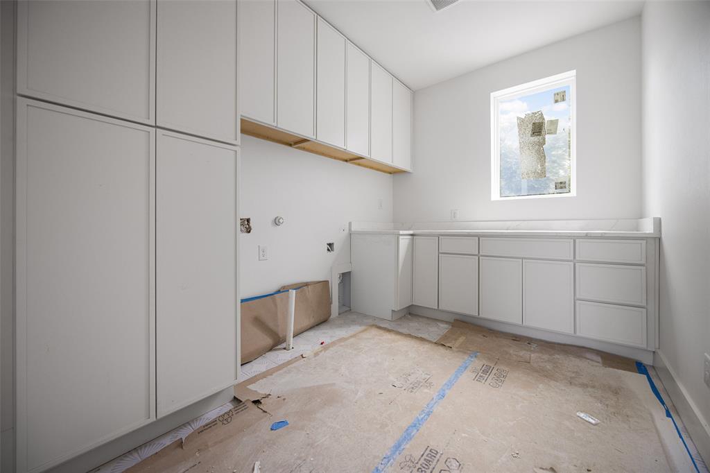 9220 Ferndale Road Dallas, TX 75238 - Photo 18 of 30 Abundant white cabinetry, integrated cabinetry, white countertop, and a window