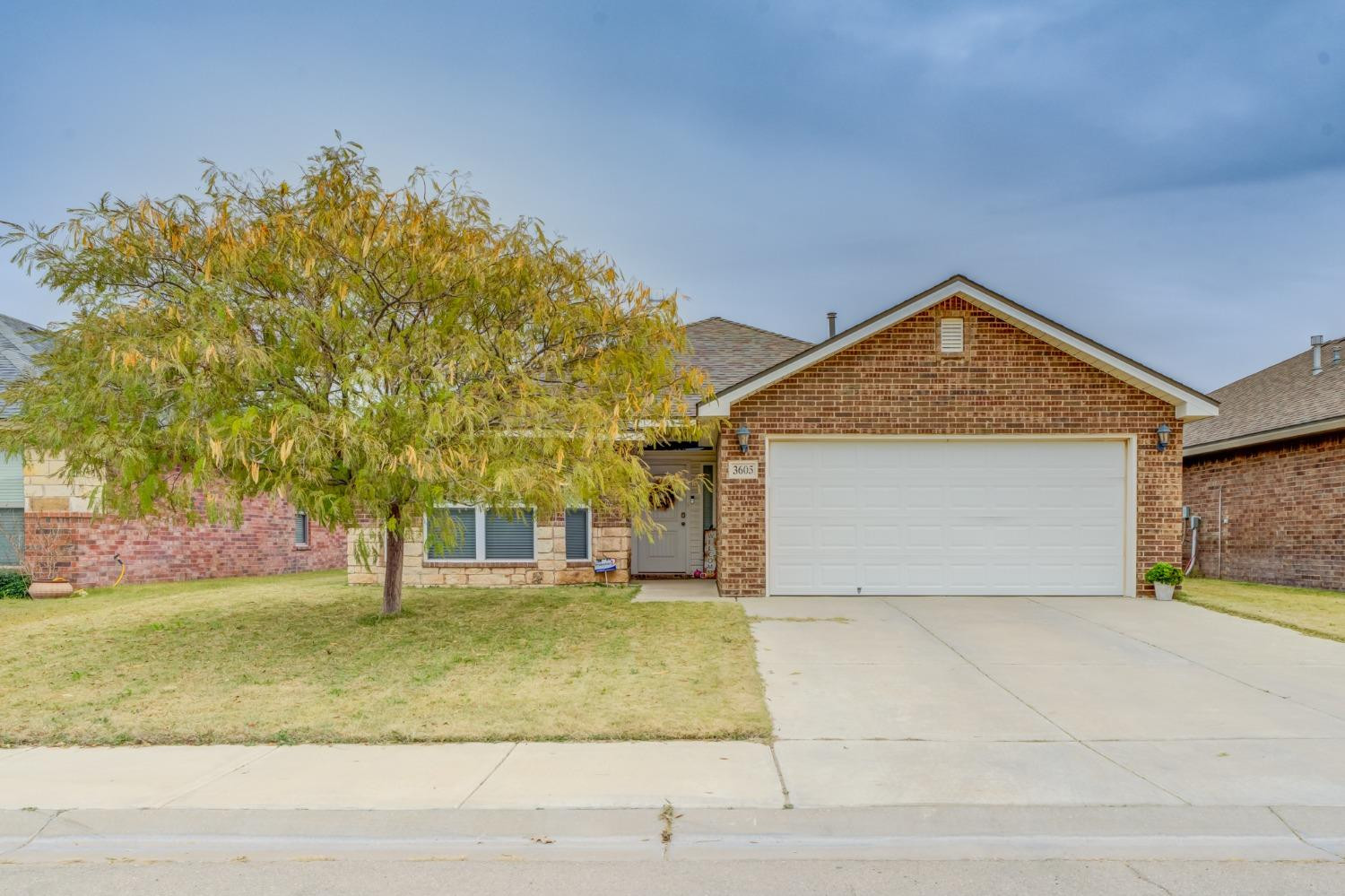 3605 Ridgely Lubbock, TX 79407 - Photo 1 of 36 a front view of a house with a yard and garage