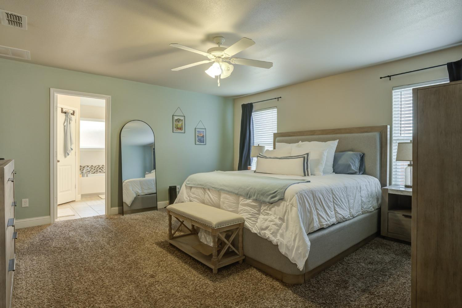 3605 Ridgely Lubbock, TX 79407 - Photo 21 of 36 a bed room with a bed and a chandelier