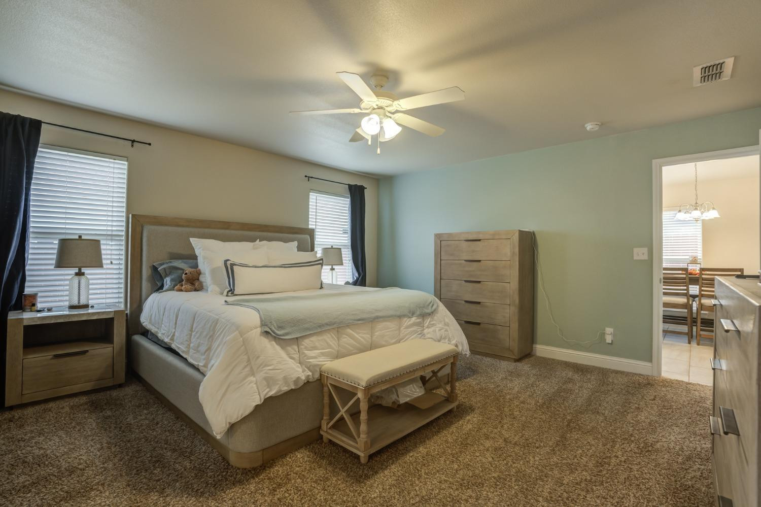 3605 Ridgely Lubbock, TX 79407 - Photo 23 of 36 a bedroom with a bed and a chandelier