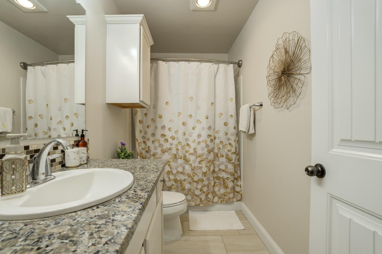 3605 Ridgely Lubbock, TX 79407 - Photo 29 of 36 a bathroom with a sink a toilet and shower