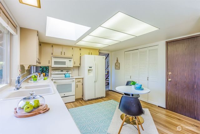 a living room with furniture a rug and wooden floor