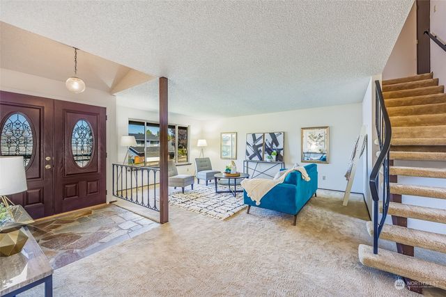 a living room with furniture a ceiling fan and a window