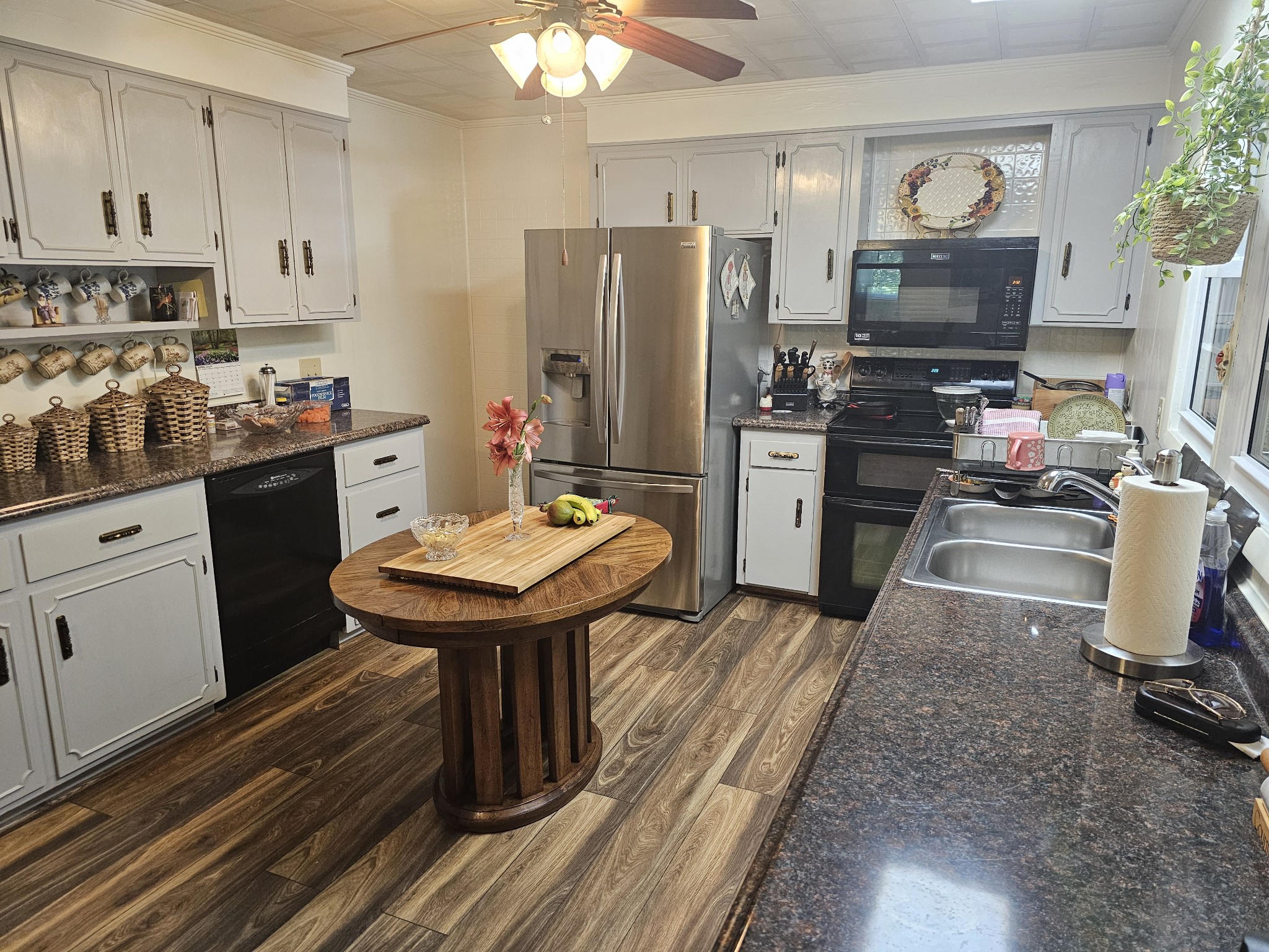 20 Fleeman Road Lawrenceburg, TN 38464 - Photo 7 of 17 a kitchen with refrigerator a stove a sink cabinets and a dining table