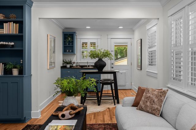 a living room with furniture and a potted plant