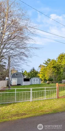 a view of a swimming pool with a brick house next to a yard