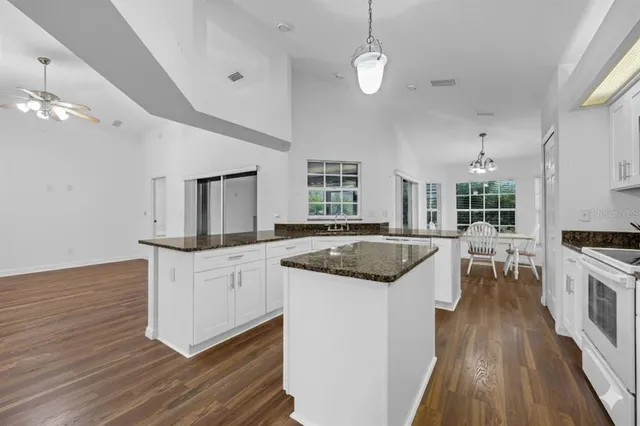 a kitchen with granite countertop a stove and a sink
