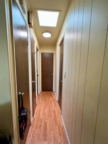 a view of gallery with wooden floor