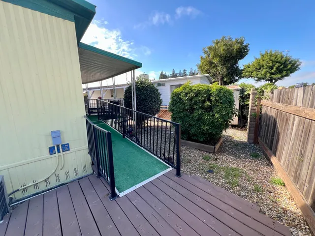 a view of a porch with couches and potted plants