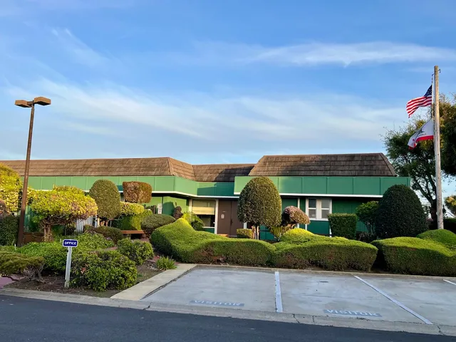 a view of swimming pool with deck in front of house