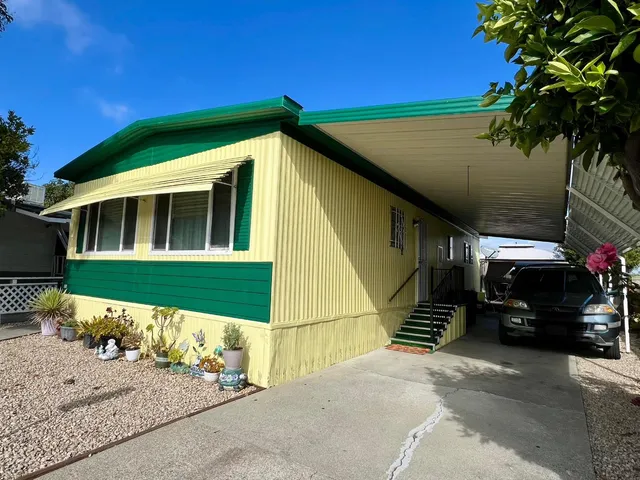 a view of a car park in front of a house