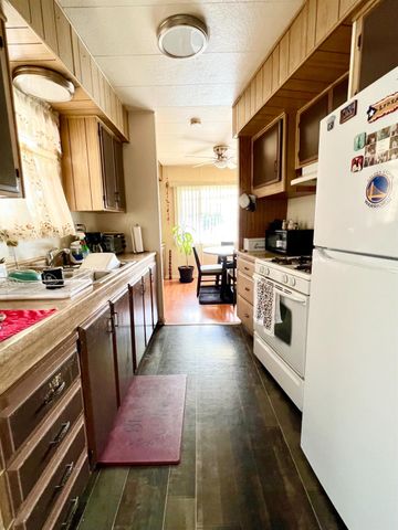 a kitchen with a stove a sink and a refrigerator