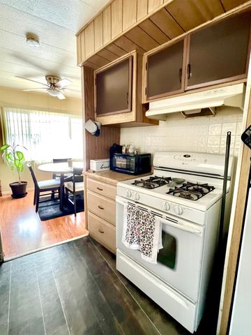 a kitchen with stainless steel appliances granite countertop a stove and a microwave