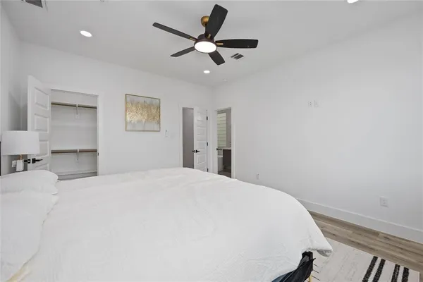 a bedroom with a large bed and a window