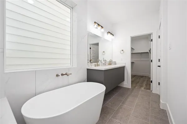 a bathroom with a tub a toilet and a shower