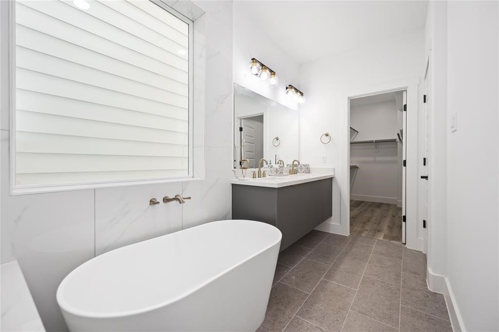 1805 Emir Street, Unit M Houston, TX 77009 - Photo 18 of 35 a bathroom with a sink a toilet and mirror