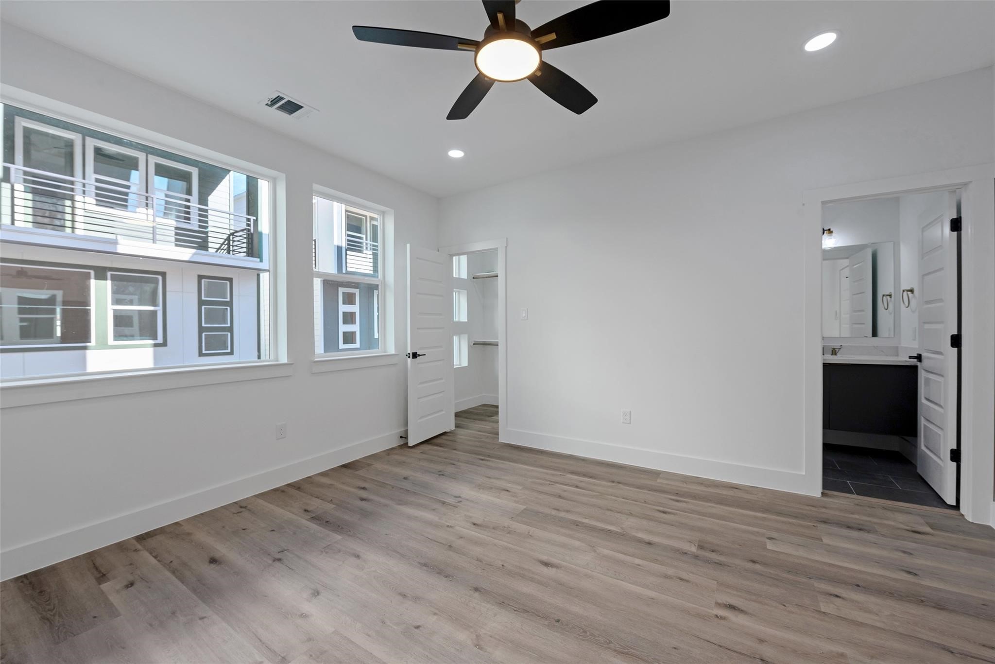 1805 Emir Street, Unit M Houston, TX 77009 - Photo 20 of 35 a view of an empty room with a window and wooden floor