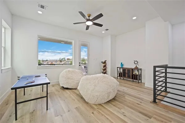 a living room with furniture and wooden floor