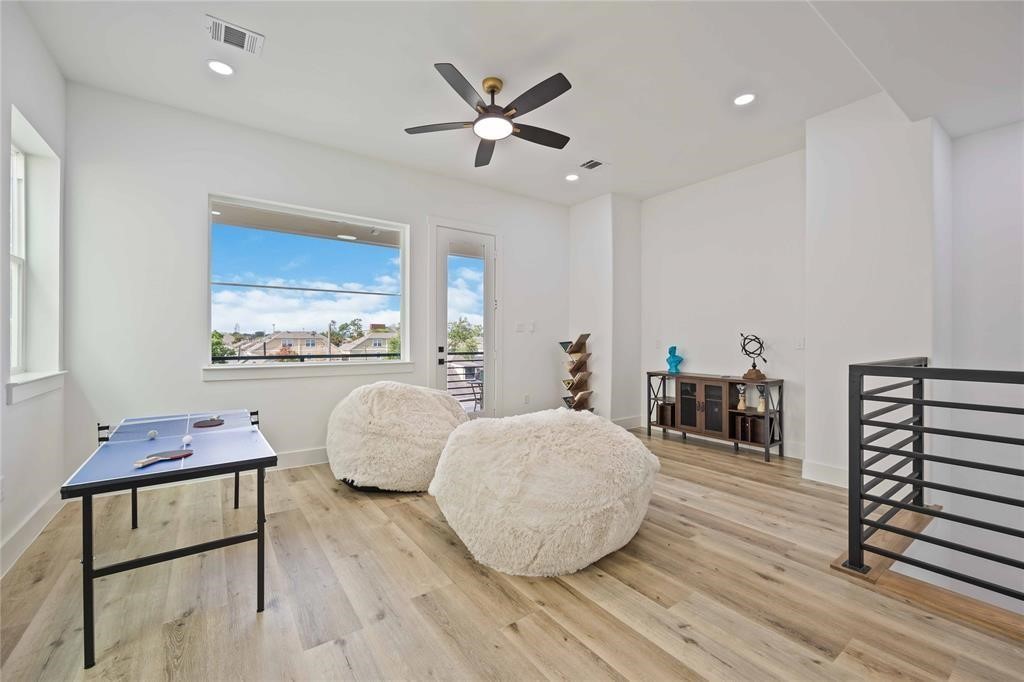 1805 Emir Street, Unit M Houston, TX 77009 - Photo 26 of 35 a bedroom with furniture and a wooden floor