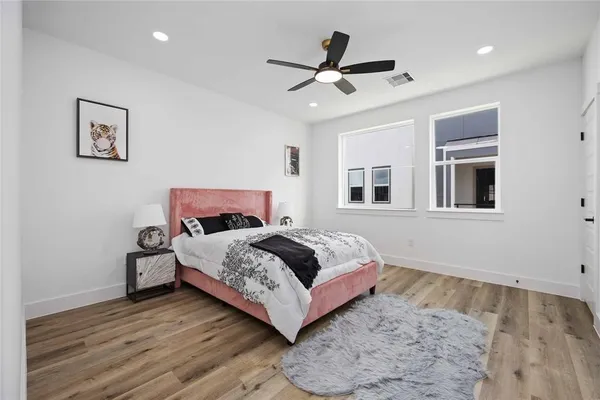 a bedroom with furniture and a wooden floor
