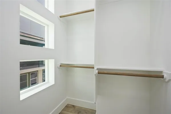 a spacious bedroom with a bed and a ceiling fan