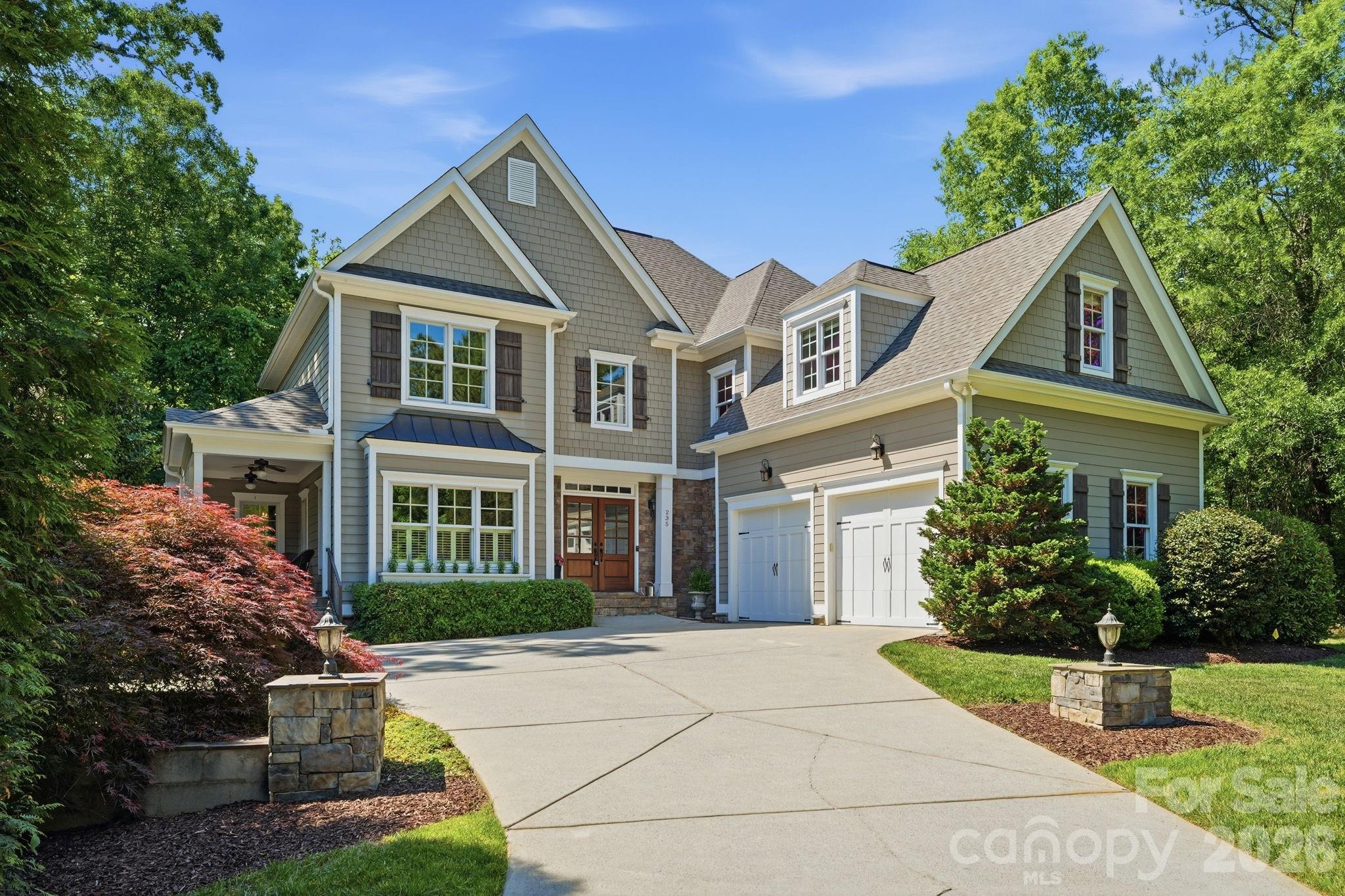 a front view of a house with a garden