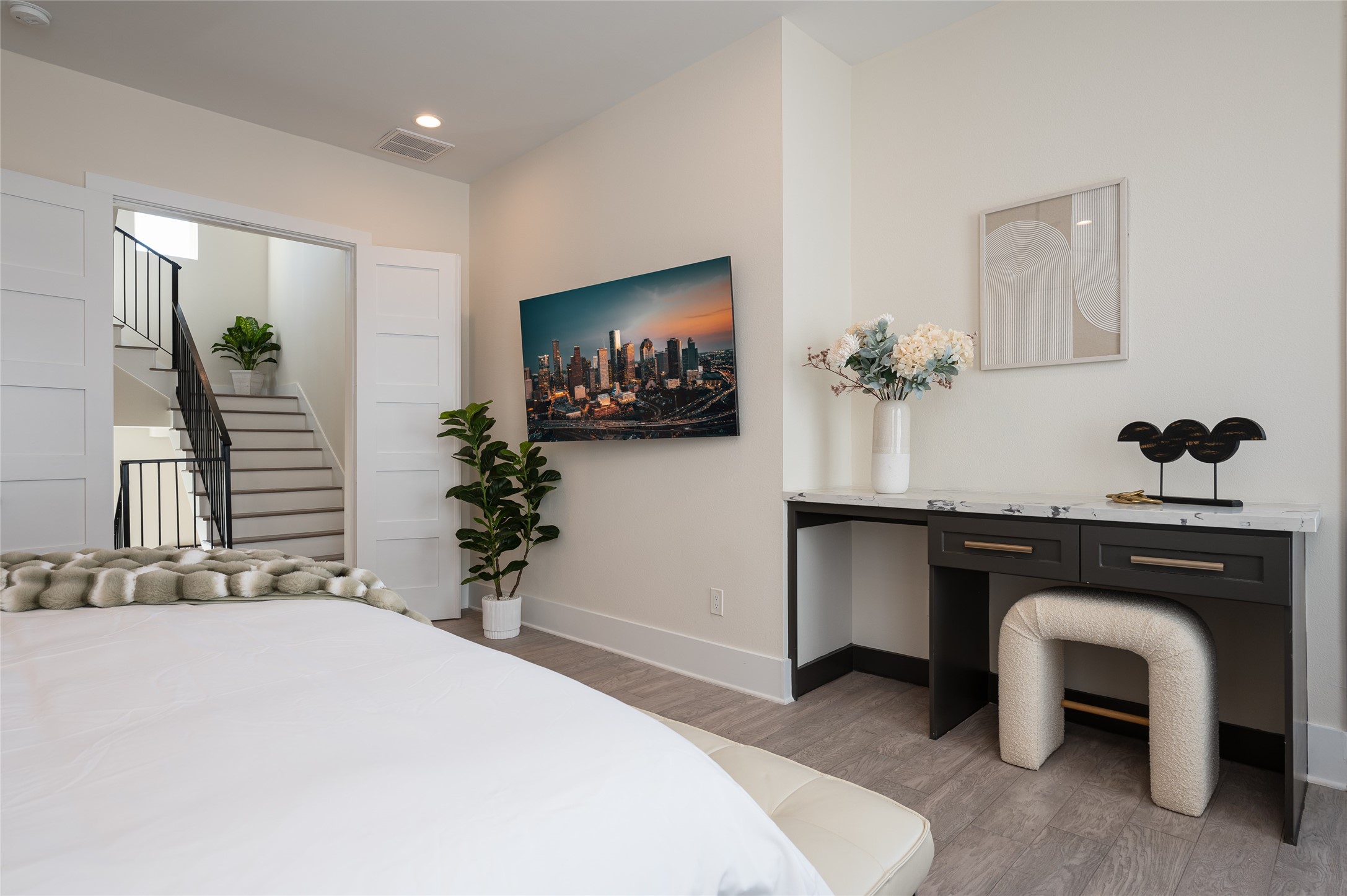 913 Thompson Street Houston, TX 77007 - Photo 13 of 49 a bedroom with a bed and a flat screen tv