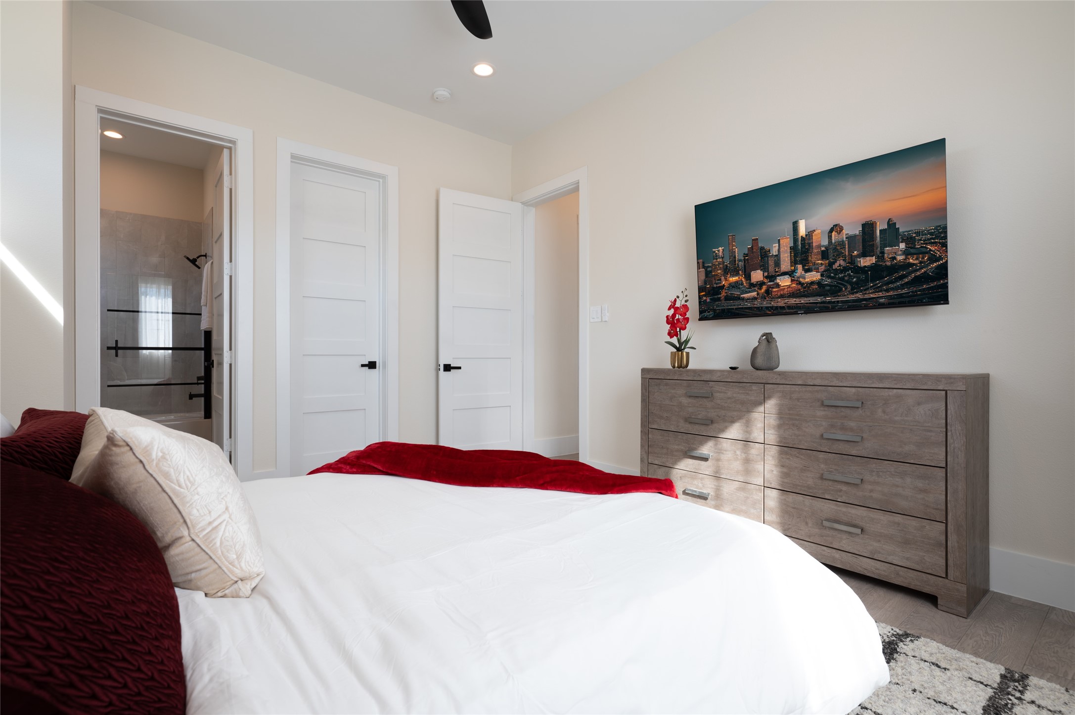 913 Thompson Street Houston, TX 77007 - Photo 14 of 49 a bedroom with a bed and a flat screen tv