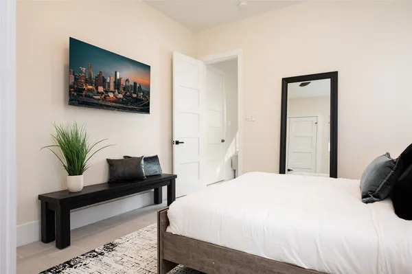 a bedroom with a bed and a painting on wall