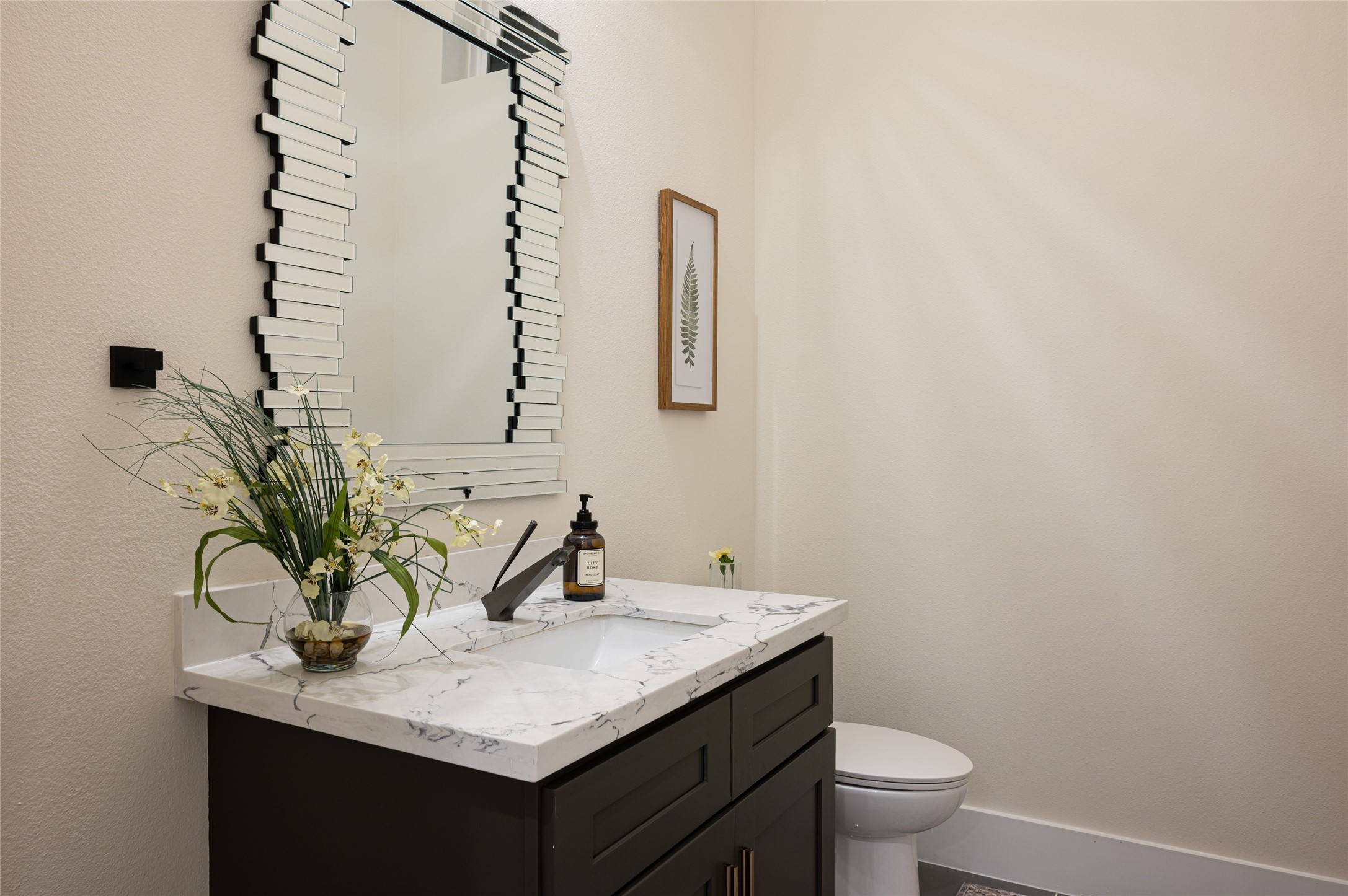 913 Thompson Street Houston, TX 77007 - Photo 18 of 49 a bathroom with a granite countertop sink and a mirror