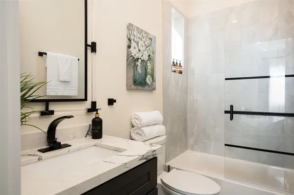 a bathroom with a sink toilet and shower