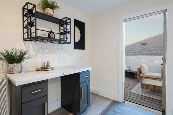 a en suite bathroom with a granite countertop sink and a mirror