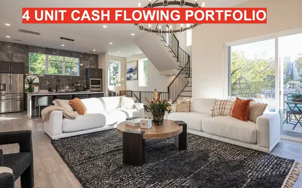 a view of a livingroom with furniture wooden floor and a floor to ceiling window
