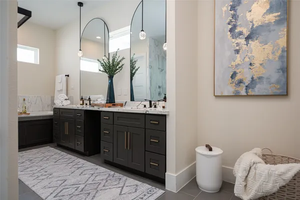 a bathroom with a double vanity sink and a mirror