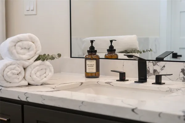 a kitchen with a sink and a mirror