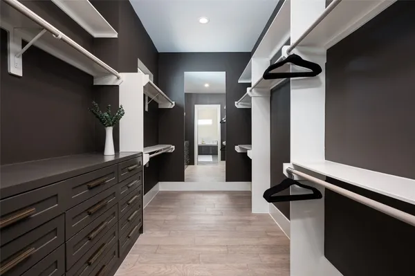 a bedroom with a bed and a potted plant