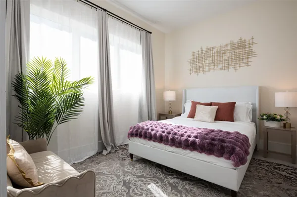 a bedroom with a bed and a potted plant