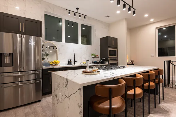 a kitchen with granite countertop a stove and a microwave