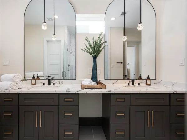 a bathroom with a double vanity sink and a mirror
