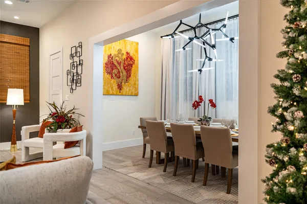 a view of a dining room with furniture and chandelier