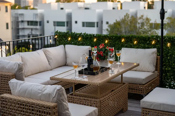 a view of a patio with couches table and chairs and potted plants