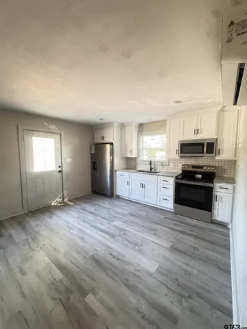 a view of kitchen with wooden floor